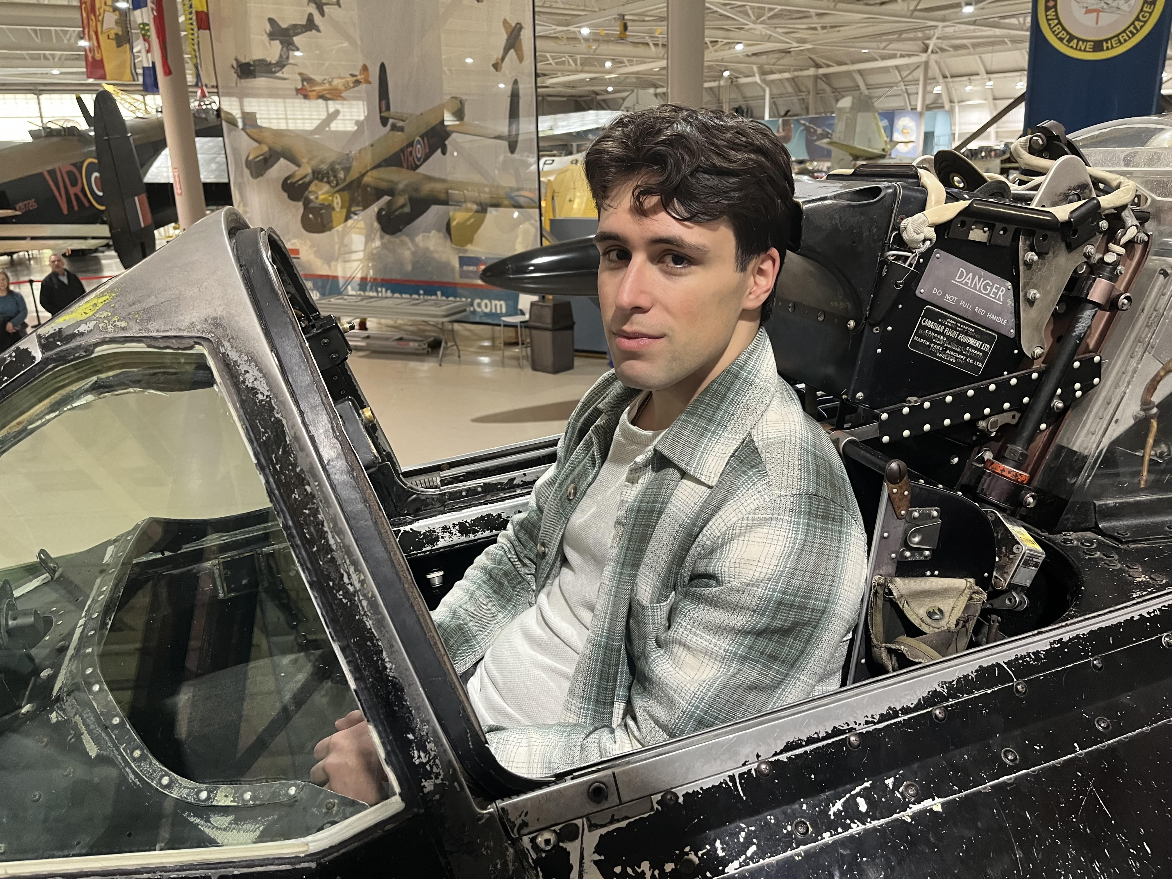 Andre Azevedo sitting in the cockpit of a historic aircraft